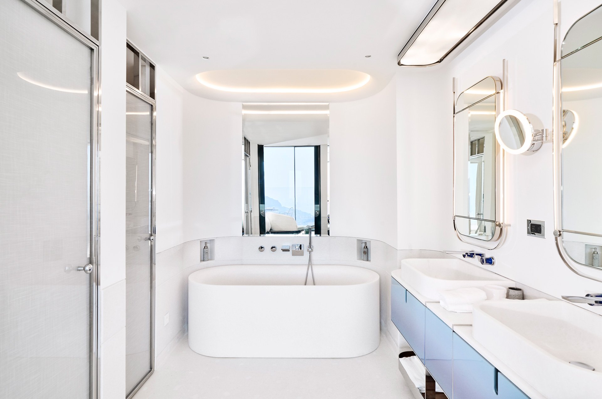 A spacious white bathroom with a white bathtub.
